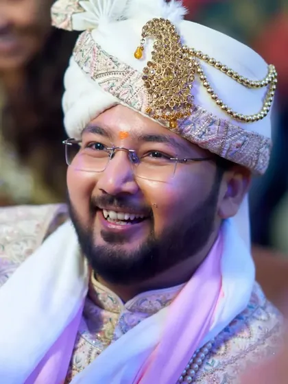 A candid smile from the groom. I believe in creating a look that enhances your natural features, making you feel like the best version of yourself.