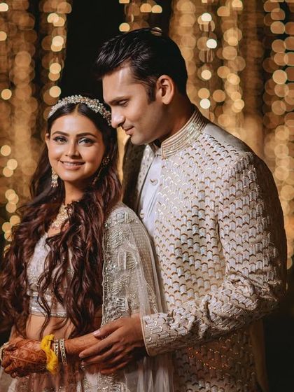 A romantic portrait of the couple against a backdrop of beautiful bokeh from the fairy lights.