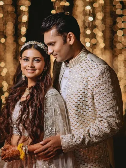 A romantic portrait of the couple against a backdrop of beautiful bokeh from the fairy lights.
