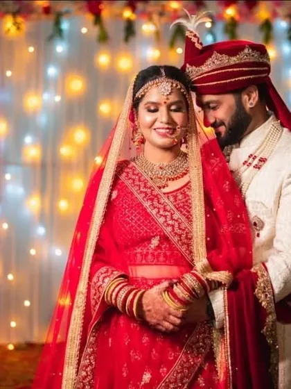 A classic wedding portrait against a backdrop of fairy lights. The soft glow creates a romantic and timeless feel for this couple's photo.