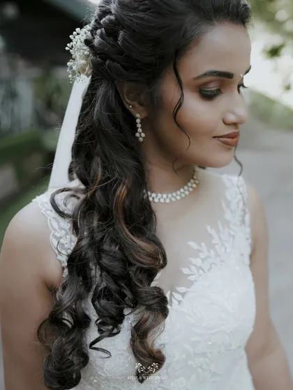 A close-up of the bride's intricate hairstyle and flawless makeup, showing the attention to detail in her bridal look.
