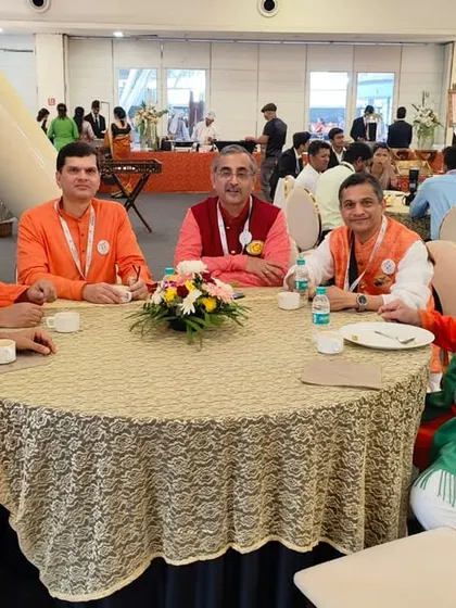 A table of distinguished guests enjoying the food and ambiance at the Vishwa Marathi Sammelan.
