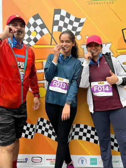 A family celebrating their 5k finish together. Running is a great activity for the whole family.