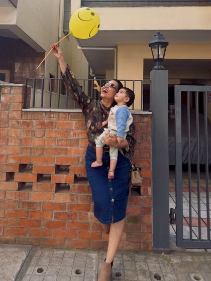 A happy, candid photo of me and Gauri with a smiley-face balloon. This image is full of joy and captures the simple, happy moments that make up our family life, perfect for brands that want to associate with positivity.