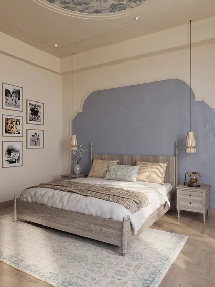 Rooted in soft blue tones, this bedroom blends contemporary lines with traditional influences. The arched niche behind the bed and the detailed ceiling moulding add character and a sense of calm sophistication.