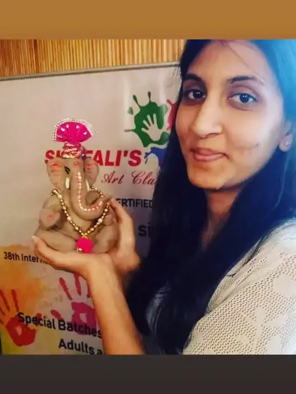 She holds her handmade Bappa, a result of her focus and creativity. It's a joy to see adults reconnect with their artistic side in my workshops.