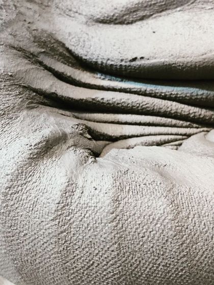 The deep grooves and folds in the clay show the physical effort that goes into preparing it for creating. This is where the conversation with the clay truly begins.