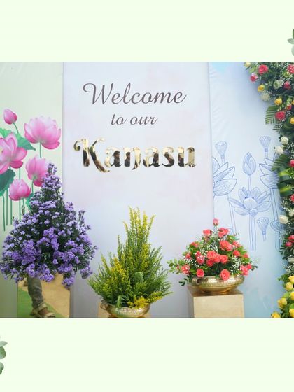 A dream come true moment, beautifully captured at the entrance of the "Kanasi" housewarming. The custom welcome sign and floral arrangements celebrate the family's new beginning.