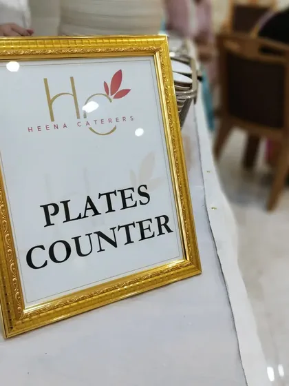 A simple, elegant sign for the "Plates Counter," framed in gold to match the luxurious theme of the event.