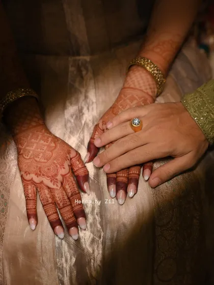 A beautiful shot of the bride and groom's hands, showing the lovely henna stain. Even the groom's simple design has a great color.