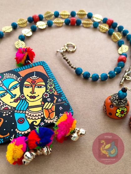 A closer look at the vibrant Radha Krishna necklace set. This angle shows the texture of the acrylic beads and the playful movement of the colourful pompoms and brass ghungroos.