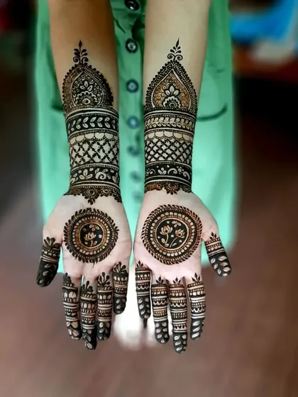 A stunning mandala design with lotus details for a guest. The intricate bands on the wrist and fingers make it look very rich and full.