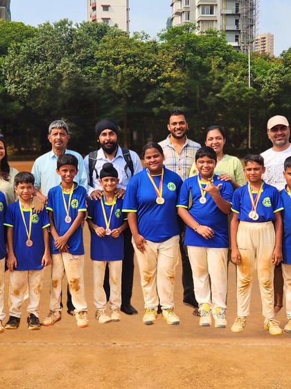 Parents and coaches celebrating with a winning team. We foster a community atmosphere where families are part of the success story.