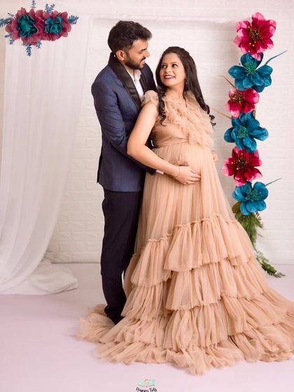 The loving gaze between them is everything. This shot captures the beautiful dynamic of the couple during their elegant maternity session.