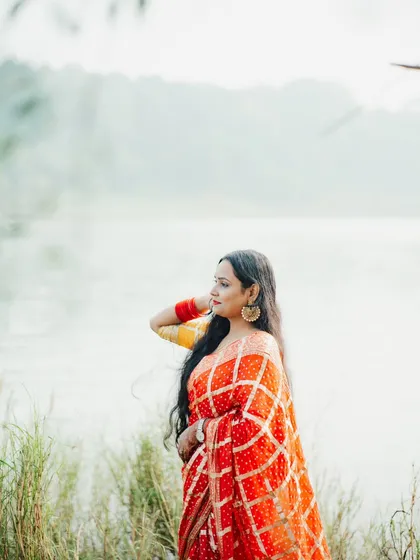 This portrait, taken by a serene lake in Jabalpur, shows a softer, more tranquil side of my work. The natural setting and the beautiful bandhani saree come together to create a timeless and graceful image.
