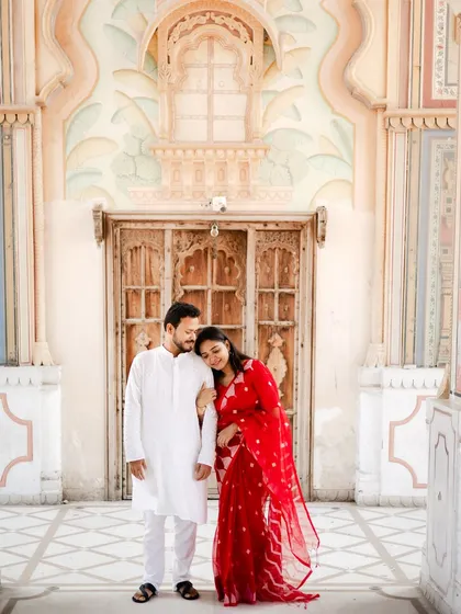 A sweet and simple pose, with the bride resting her head on her partner's shoulder, framed by the stunning archways of Patrika Gate.