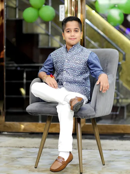A stylish portrait of the birthday boy, looking sharp in his traditional attire. I also specialize in posed kids' photography to complement the candid shots from the event.