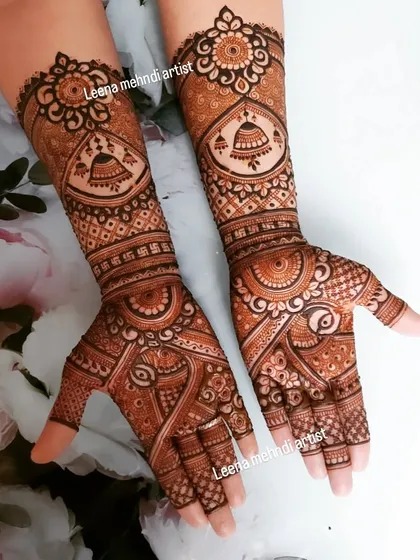 A lovely bridal design featuring jhumka (traditional earring) motifs. The pattern is a beautiful mix of geometric grids, floral elements, and the auspicious swastika symbol.