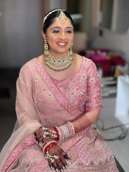 Nilomi's complete look, ready for her wedding. The soft pink theme is carried through from her lehenga to her makeup for a cohesive and elegant style.