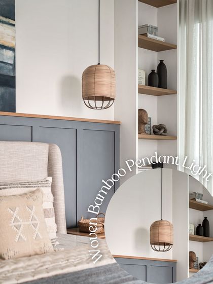 Lighting can define any space. This woven bamboo pendant light adds a touch of natural texture and warmth to the bedroom, perfectly complementing the grey wainscoting and creating a soft, ambient glow.