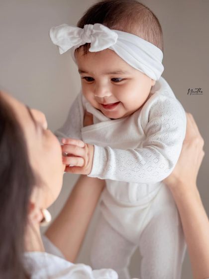 A close-up of a mother holding her baby girl.