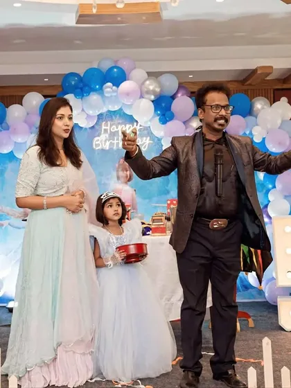 The birthday girl with her mother and the magician during a fun interactive trick at her Frozen-themed party.