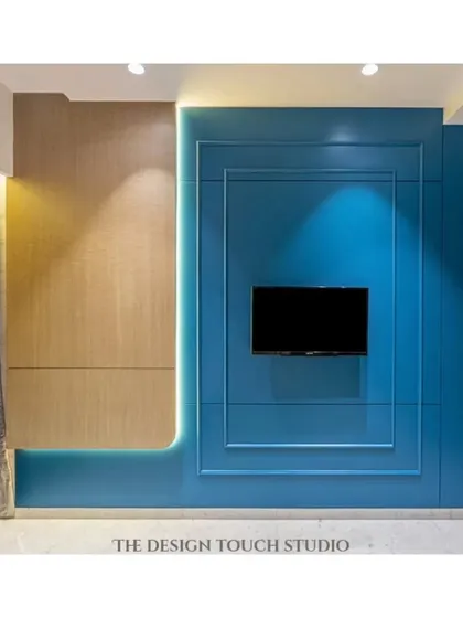 This bedroom features a bold royal blue accent wall with a modern, floating bed that has LED underglow. The design is both visually striking and highly functional.
