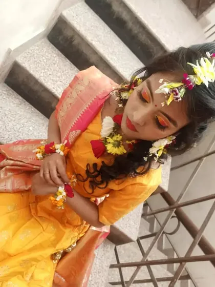 Our students learn about posing and lighting to capture their work. This full-length shot showcases the complete Haldi ceremony look, including the makeup, floral accessories, and traditional attire, creating a portfolio-worthy image.