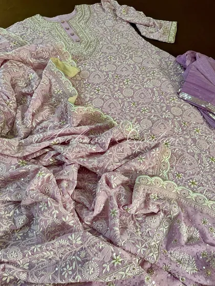 An overhead shot displaying the full expanse of the lilac Anarkali, emphasizing the sheer amount of artisanal work involved.