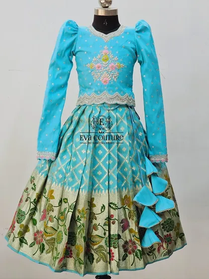 The same long-sleeved lehenga design in a bright sky blue, showing how I can customize colors.