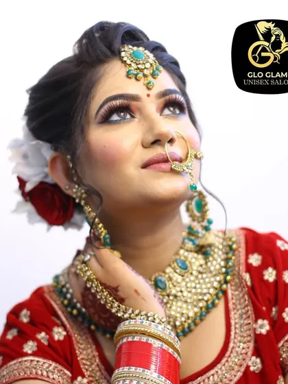 A close up of one of my brides, showcasing a classic Indian bridal makeup look. Notice the perfectly blended eyeshadow, sharp winged liner, and how the makeup complements her red lehenga and traditional jewellery for a timeless and elegant result.