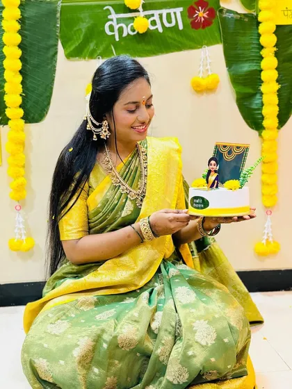 The beautiful bride-to-be holding her custom Kelvan cake. We are so happy she loved how the topper matched her saree.