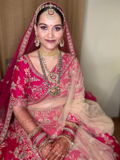 This bride looks absolutely radiant. I used a rose gold glitter on the eyes and a deep mauve lip color to create a sophisticated and modern look that still feels perfectly bridal.