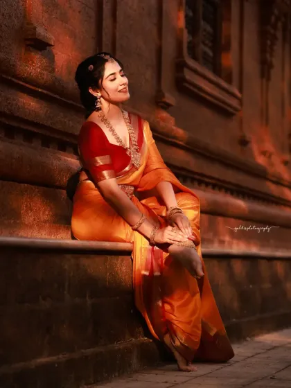 A beautiful shot of the bride seated and enjoying the last rays of the sun. The lighting is warm and flattering, creating a peaceful and romantic mood.