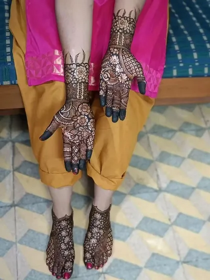 A complete set of hand and foot mehendi. The matching intricate patterns create a stunning look from head to toe.