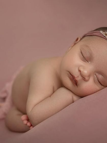 A close up side view, capturing the baby's delicate eyelashes and lips. These simple, posed shots are perfect for highlighting all the tiny details.