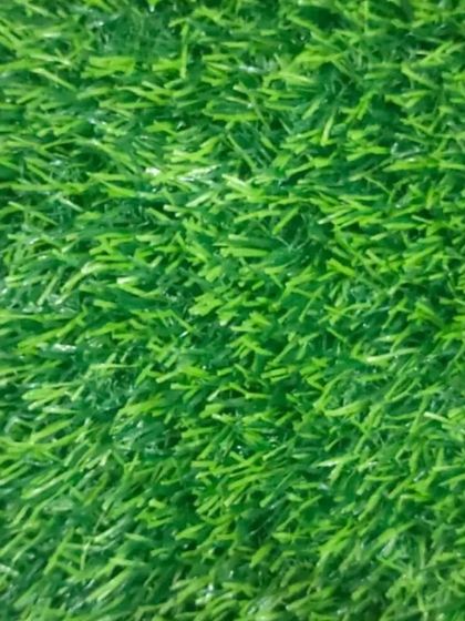 A close-up view of the artificial grass fibers. We use products that are soft to the touch and resilient to foot traffic.