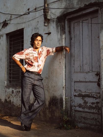 Zahan Kapoor leaning against an old door, a shot that feels both styled and completely natural. The setting adds so much character.