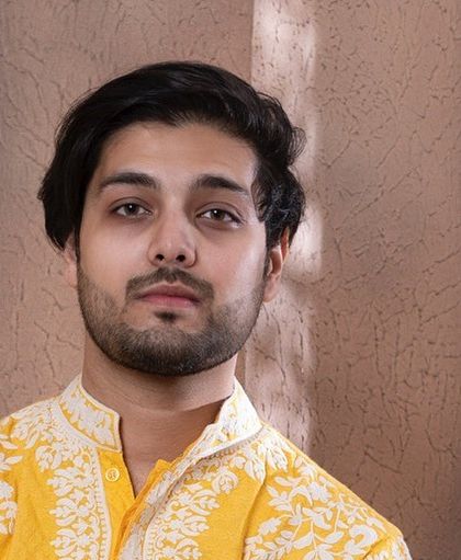 This portrait highlights the fine craftsmanship of the embroidery on our zesty yellow kurta.