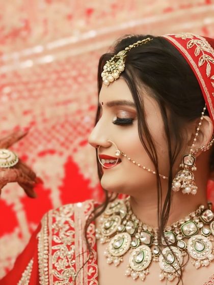 My bride Tamanna, with a happy, candid smile. The side profile shows off her soft eye makeup and beautiful nath.