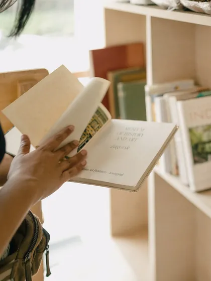 Flipping through a vintage book from our collection. Our mini library has always been a place for guests to read while enjoying their coffee.