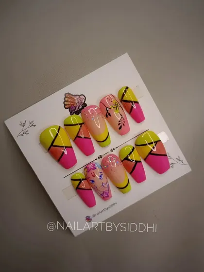 A custom set of press-on nails created for Ganesh Chaturthi. The design features bright colors, geometric patterns, and a miniature Ganesha portrait.
