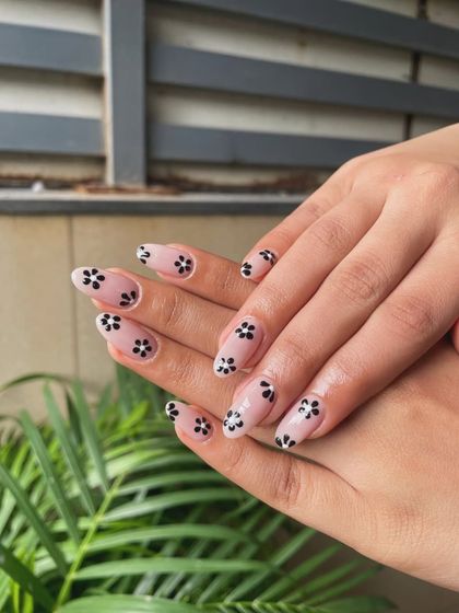 Simple, chic, and stylish. We created this minimalist look by hand-painting small black flowers on a clean, natural-looking nude base for an effortlessly cool design.