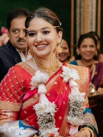 A candid shot of the bride during the ceremony. Her joyful expression and glowing skin are a testament to a look that feels comfortable and beautiful.