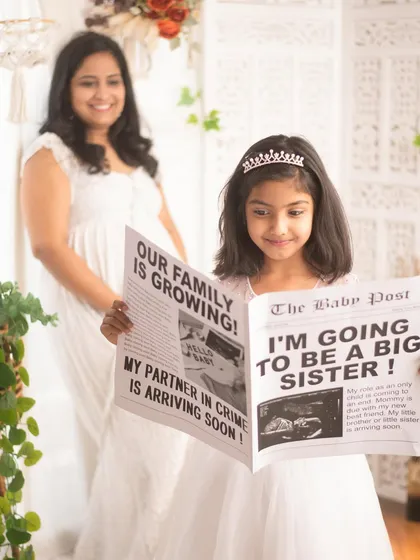 Sibling announcements are so much fun. We used a custom newspaper prop to help this big-sister-to-be share the exciting news. It’s a joy to capture these precious family milestones.