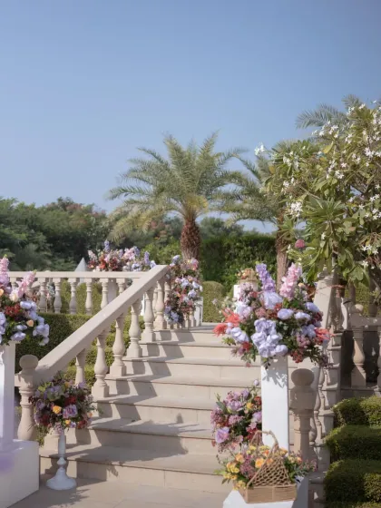 The natural beauty of the venue's stone staircases, enhanced with lush, colorful floral arrangements to guide guests through the space.