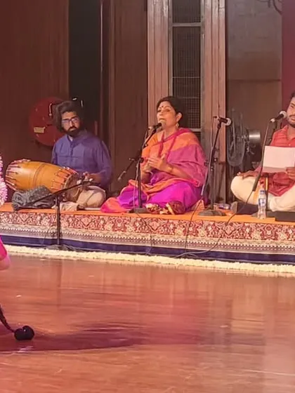 A full-stage view of Stuti Mukherjee's arangetram, with the live orchestra seated on one side. This image captures the complete atmosphere of a traditional Bharatanatyam recital.