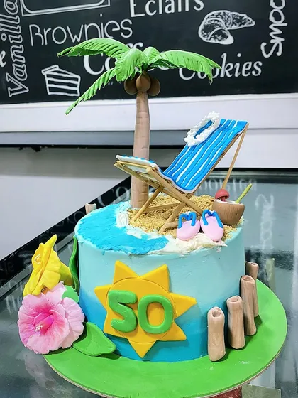 A beach-themed cake for a 50th birthday. The design features a beach chair, palm tree, and edible sand, perfect for someone who loves the coast.