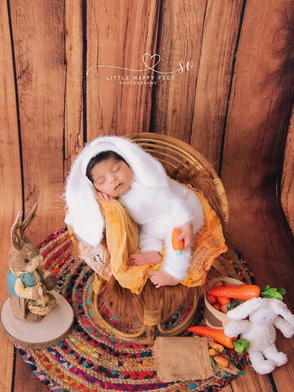 Our little hunny bunny in a rustic papasan chair. The mix of textures, from the smooth wood to the colorful rug, adds a lot of visual interest to this shot.