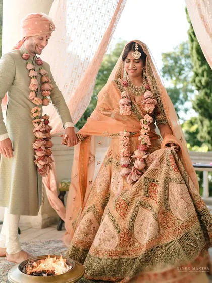 Hand in hand, they begin their journey. This shot captures the couple during their pheras at their destination wedding in Italy, the natural beauty of the location providing a stunning backdrop.